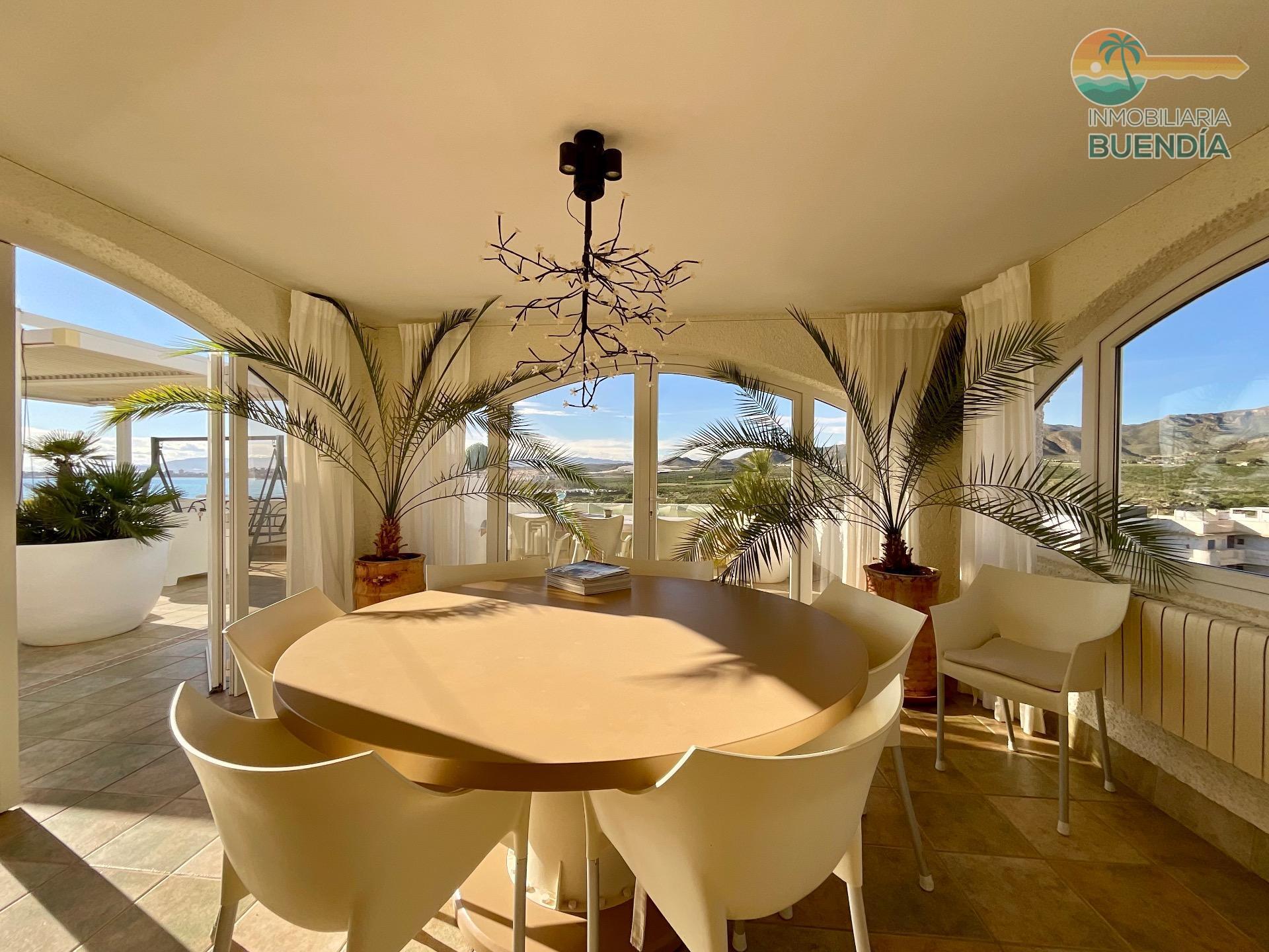 Sunlit dining terrace with sea views
